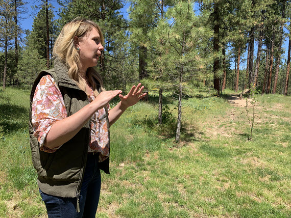 Mary talking in a field with trees