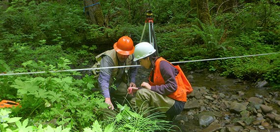 Two technicians doing stream monitoring in the OESF